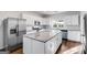 Modern kitchen with stainless steel appliances, white cabinets, granite countertops, and a large island at 734 W College St, Bowdon, GA 30108