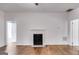 Cozy living room with hardwood floors, a decorative fireplace, and neutral walls at 734 W College St, Bowdon, GA 30108