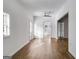 Large living room with hardwood floors, white walls, a ceiling fan, and multiple entryways at 734 W College St, Bowdon, GA 30108