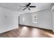 The living room is bright and airy with stylish floors, a ceiling fan, and ample natural light at 734 W College St, Bowdon, GA 30108
