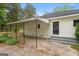A covered patio on the side of the house offers a secluded space at 734 W College St, Bowdon, GA 30108
