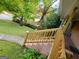 Charming front yard featuring a well-maintained lawn, mature trees, and a stairway to the house at 1723 Fort Valley Sw Dr, Atlanta, GA 30311