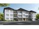 Inviting three story condo building featuring balconies, brick accents and mature landscaping at 1000 Blair Ln # 102, Peachtree City, GA 30269