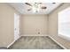 Bright bedroom with neutral carpet, a ceiling fan, and a window for great natural light at 130 Nicki Ct, Hampton, GA 30228