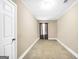 An empty room with neutral carpet and a single window provides a blank canvas for endless possibilities at 130 Nicki Ct, Hampton, GA 30228