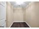 A versatile empty room with dark hardwood floors and a decorative textured white ceiling at 130 Nicki Ct, Hampton, GA 30228