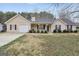 Charming home featuring manicured landscaping, a covered front porch, and a well-maintained lawn at 130 Nicki Ct, Hampton, GA 30228