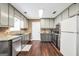 Well-lit kitchen featuring sleek appliances, granite countertops, and ample cabinet space at 130 Nicki Ct, Hampton, GA 30228