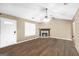 Bright living room featuring wood floors, a stone fireplace, and a large window at 130 Nicki Ct, Hampton, GA 30228