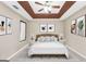 Elegant main bedroom showcasing a decorative tray ceiling, ceiling fan, and coordinated decor at 130 Nicki Ct, Hampton, GA 30228