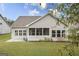 Back exterior view showing the screened in porch area with double pane windows on a well manicured lawn at 240 Grand Oak Way, Sharpsburg, GA 30277