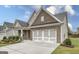 Charming single-Gathering home featuring a brick facade, two-car garage, manicured lawn and inviting landscaping at 240 Grand Oak Way, Sharpsburg, GA 30277