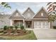 Charming home featuring a brick facade, gabled roof, and a well-manicured front yard with lush landscaping at 240 Grand Oak Way, Sharpsburg, GA 30277