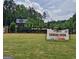 Future retail building with modern architectural design and a coming soon banner in a landscaped community at 240 Grand Oak Way, Sharpsburg, GA 30277