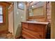 Bathroom with antique vanity, shower stall, and brick accent wall at 1024 Bethany Rd, Covington, GA 30016