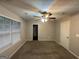 Cozy bedroom with window, ceiling fan and carpet flooring at 208 Rankin Cir, Mcdonough, GA 30253