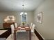 Elegant dining room with a wood table, chandelier, and hardwood floors at 208 Rankin Cir, Mcdonough, GA 30253