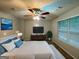 Spacious main bedroom with large window, ceiling fan and dresser at 208 Rankin Cir, Mcdonough, GA 30253