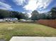 Large backyard with green grass and wooden fence at 2299 Church St, Hampton, GA 30228