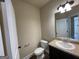 Simple bathroom with toilet, sink, and dark vanity at 2299 Church St, Hampton, GA 30228