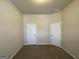 Spacious bedroom with two doors and neutral carpeting at 2299 Church St, Hampton, GA 30228