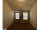 Bright bedroom with two windows and neutral carpeting at 2299 Church St, Hampton, GA 30228