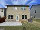 Tan house exterior with brick base and small patio at 2299 Church St, Hampton, GA 30228