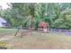 Wooden storage building in backyard; swing set visible at 399 Towler, Loganville, GA 30052