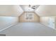 Spacious carpeted bonus room featuring a ceiling fan and bright window at 625 Aya Cir, Loganville, GA 30052