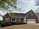Charming brick home with a two-car garage and well-maintained landscaping at 625 Aya Cir, Loganville, GA 30052