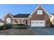 Inviting brick home featuring a covered porch and two-car garage at 625 Aya Cir, Loganville, GA 30052
