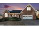 Beautiful brick home with well-manicured landscaping and a cozy porch, set against a vibrant sky at 625 Aya Cir, Loganville, GA 30052