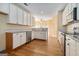 Well-lit kitchen features stainless appliances and hardwood floors at 625 Aya Cir, Loganville, GA 30052