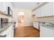Well-lit kitchen features stainless appliances, hardwood floors and granite countertops at 625 Aya Cir, Loganville, GA 30052