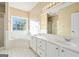 Main bathroom with a double sink vanity, soaking tub and tile flooring at 625 Aya Cir, Loganville, GA 30052