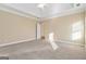 Bright main bedroom features neutral carpet, and a doorway to an ensuite bathroom at 625 Aya Cir, Loganville, GA 30052