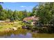 A beautiful backyard features a tranquil pond and a deck perfect for outdoor relaxation at 50 Persian Pl, Whitesburg, GA 30185