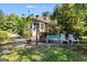 Backyard with patio and bench and lots of greenery and trees at 50 Persian Pl, Whitesburg, GA 30185