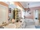 Bright bathroom features a double sink vanity, granite counters, and soaking tub at 50 Persian Pl, Whitesburg, GA 30185