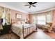 Comfortable bedroom featuring a decorative iron bed frame, floral bedding, and bright natural light at 50 Persian Pl, Whitesburg, GA 30185