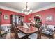 Formal dining room with elegant wood furniture, a large china cabinet, and a round mirror at 50 Persian Pl, Whitesburg, GA 30185