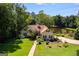 An attractive home features a manicured lawn and mature trees, offering a serene and private setting at 50 Persian Pl, Whitesburg, GA 30185
