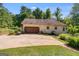 Spacious two-car detached garage with a long driveway, set amongst a backdrop of lush trees at 50 Persian Pl, Whitesburg, GA 30185