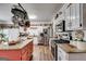 Well-equipped kitchen with stainless steel appliances, granite counters, and pot rack at 50 Persian Pl, Whitesburg, GA 30185