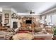 Spacious living room features a fireplace, entertainment center, and traditional decor at 50 Persian Pl, Whitesburg, GA 30185