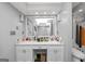 Bathroom with double vanity, white cabinets, large mirror, and a partially visible toilet and shower at 6 Alston Ne Pl, Atlanta, GA 30324