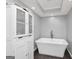 Serene bathroom with a freestanding tub, a storage cabinet, and recessed lighting at 6 Alston Ne Pl, Atlanta, GA 30324