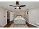 Cozy bedroom featuring a ceiling fan, neutral walls, and an upholstered bed with a decorative rug at 6 Alston Ne Pl, Atlanta, GA 30324