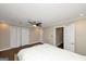 Spacious bedroom with wood floors, ceiling fan, and multiple closets and doors at 6 Alston Ne Pl, Atlanta, GA 30324