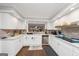 Spacious kitchen featuring white cabinetry, stainless appliances and dark wood floors at 6 Alston Ne Pl, Atlanta, GA 30324